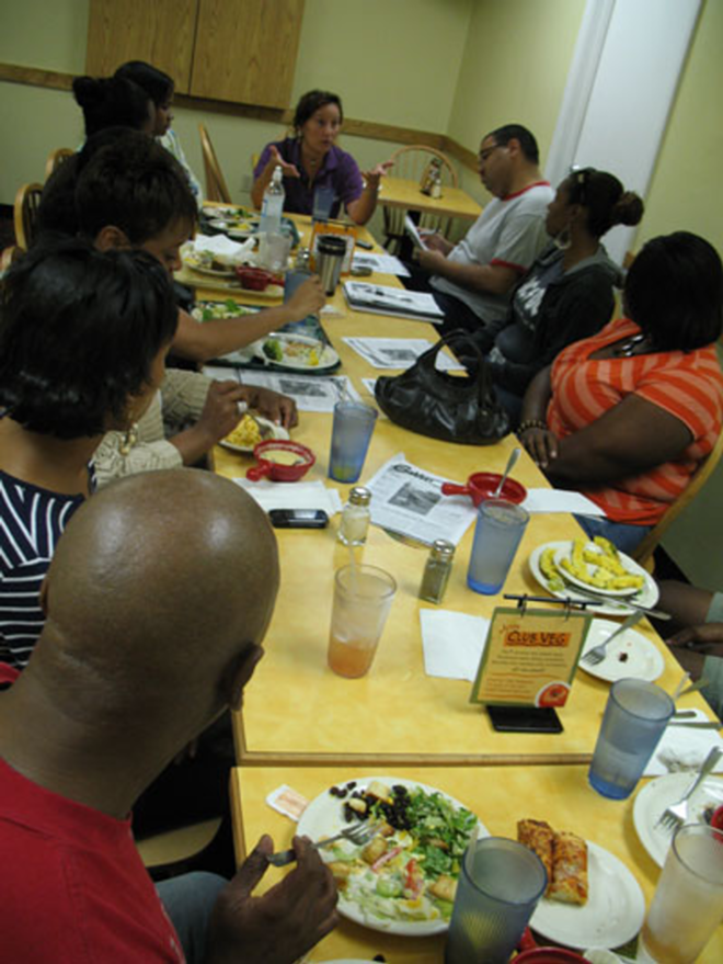 ROUNDTABLE: Cathy Salustri, sitting at the head of the table, explains her controversial article to the Tampa Bay Association of Black Journalists. - Alex Pickett