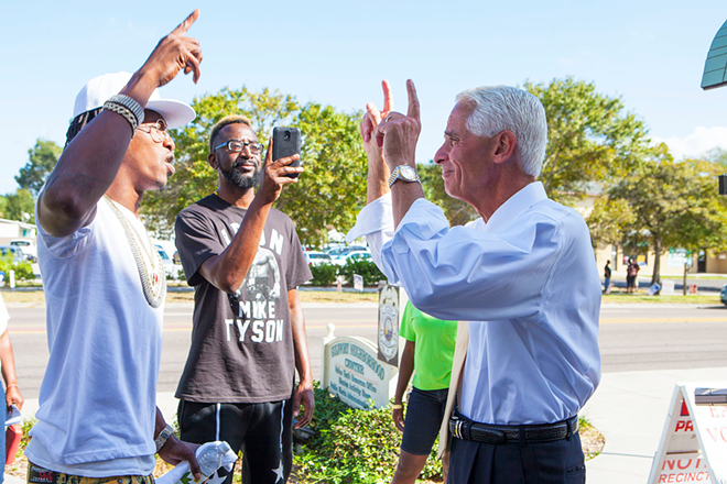 Charlie Crist talks with young voters outside the Gulfport Community Center. - Kimberly DeFalco