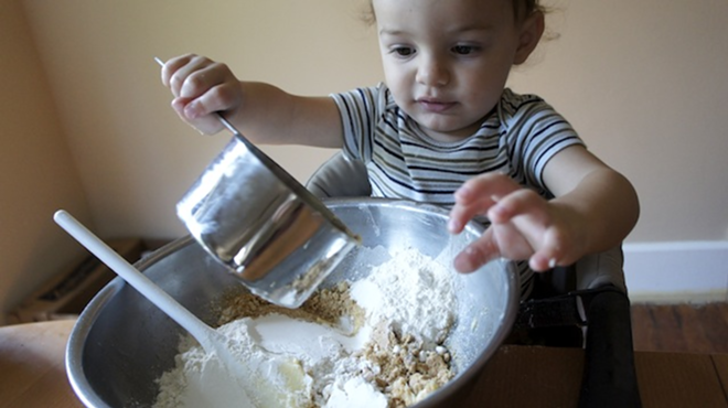 BABY BAKES: Eli at work mixing up S’more Squares. - Arielle Stevenson