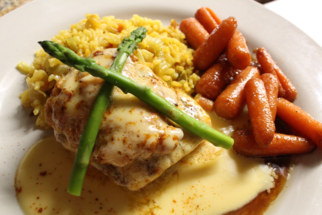Char-grilled mahi Oscar comes topped with lump crab, asparagus and hollandaise. - Laura Mulrooney