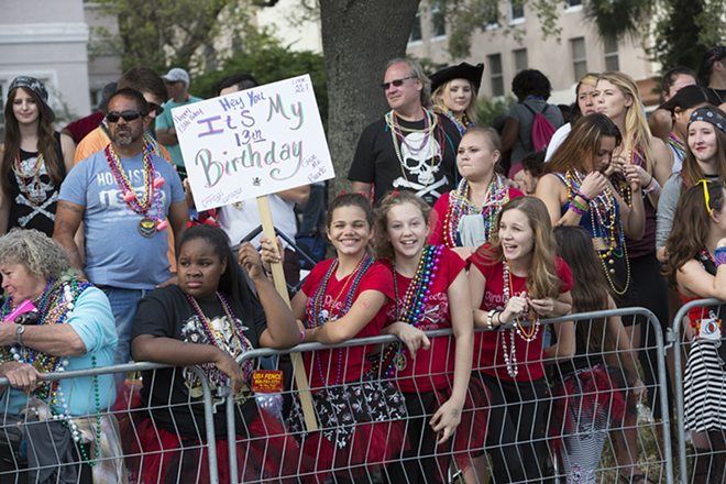 Tiffany Reyes of Tampa snagged tons of beads from pirates wishing her a happy 13th birthday. - Chip Weiner