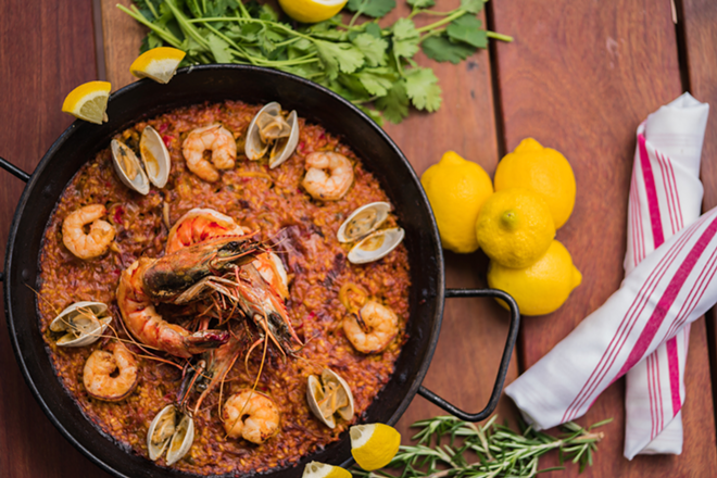 Bulla Gastrobar's paella features Valencia-style rice, seafood, saffron and red sofrito. - Bulla Gastrobar