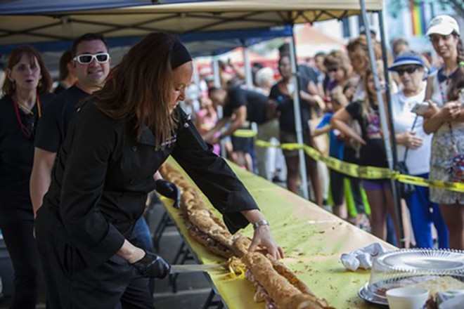 La Septima Executive Chef Darlene Herrick contributes to the world's longest Cuban Sandwich. The sandwich was donated to Tampa Bay Harvest, to help feed the hungry - KIMBERLY DEFALCO