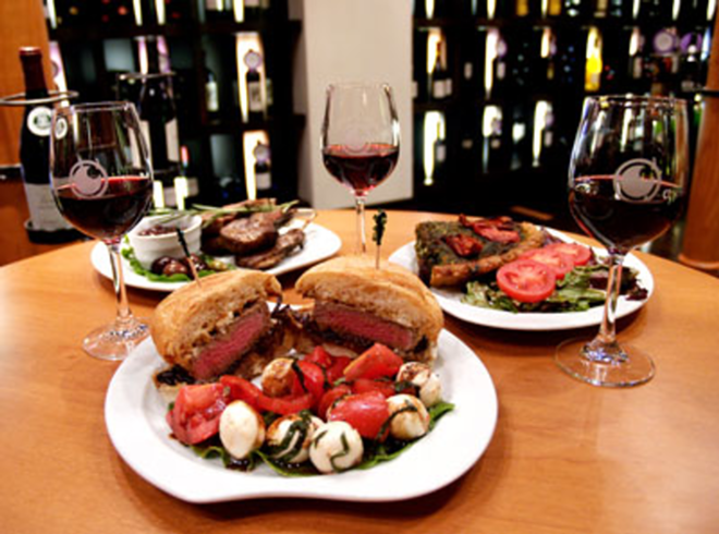 STEAK A CLAIM: The Grape's exceptional steak sandwich (center), plus chops, quiche and the beverage of choice. - Valerie Troyano