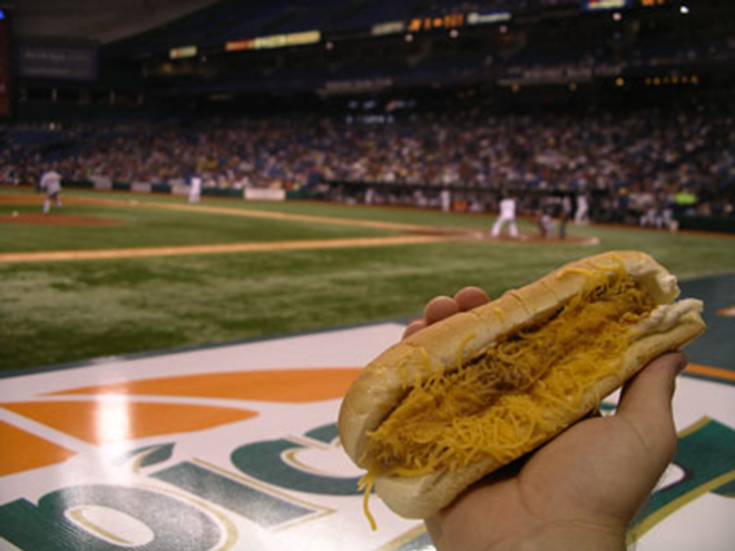 FARE BALL: The "Stinger Dog," in all its caloric glory, takes in the game from the front row. - Max Linsky