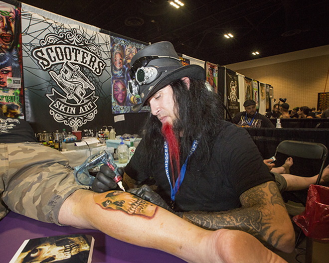 FEARLESS FREAK: Tattoo artist Mike the Freak works on a piece for Tampa Tribune reporter John Allman who was doing a special report on getting tattooed. - Chip Weiner