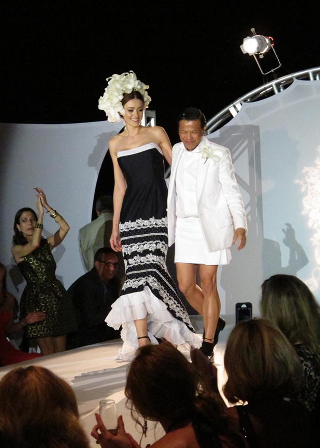 SKIRTING SUCCESS: A runway model poses with designer Zang Toi at the end of the show. - CAITLIN ALBRITTON
