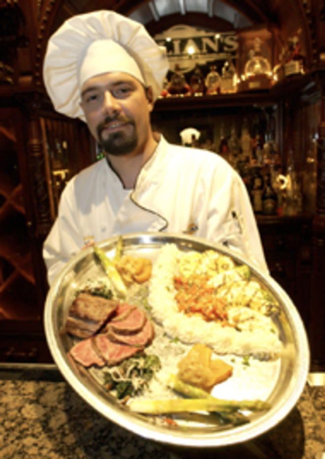 PLEASED TO MEAT YOU: Julian's chef Bobby - Prichard displays the chateaubriand for two platter, - with aged beef, grilled veggies and potatoes. - Sean Deren