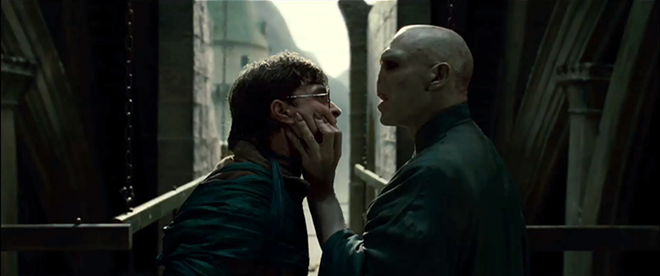 FACE-TIME: Harry Potter (Daniel Radcliffe) gets up close and personal with Lord Voldemort (Ralph Fiennes). - Warner Bros. Pictures