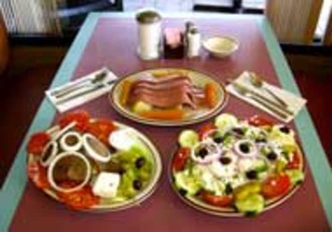 ON THE MONEY: Three Coins offers a smattering - of Greek specialties, such as (clockwise from lower - left) gyro  dinner with tzatziki sauce, corn - beef and cabbage, and Greek salad. - VALERIE MURPHY