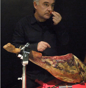 Adrià enjoys the aroma of an Ibérico ham during the exhibition’s opening. - Jon Palmer Claridge