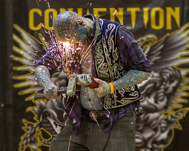 SPARKIN' A CONVERSATION: The Enigma  has an ax to grind  on the Tattoo Convention stage. What about safety glasses? - Chip Weiner