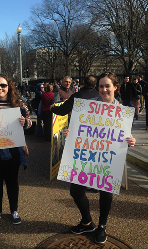 A sign holder stands outside the White House. - Mitzi Gordon