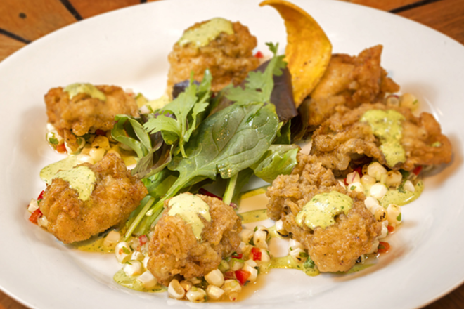 Cornmeal-crusted gulf oysters top a pepper-sweet corn relish. - Chip Weiner