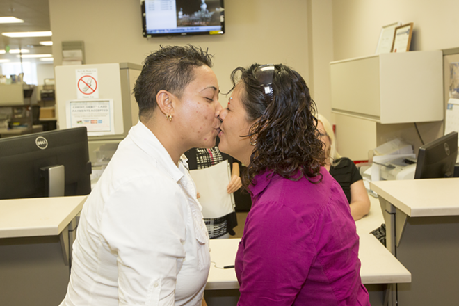 Twenty-eight minutes after filling out their marriage license application, Zahira Melendez and Alba Glendy-Loarca seal the deal. - Chip Weiner