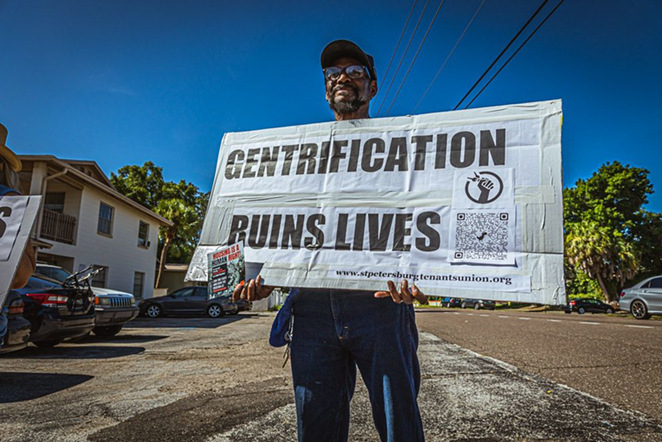 A member of SPTU holds a sign opposing gentrification. - Dave Decker