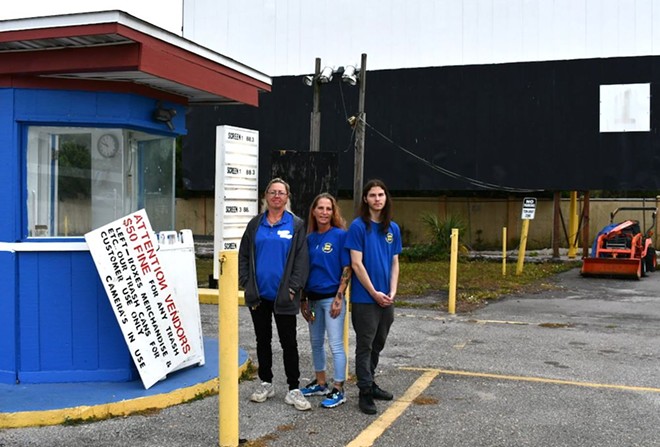 Fun-Lan workers stand next to the original ticket booth on their last day of work on the property. From left to right: Snell, Stanford and Perez. - JUSTIN GARCIA