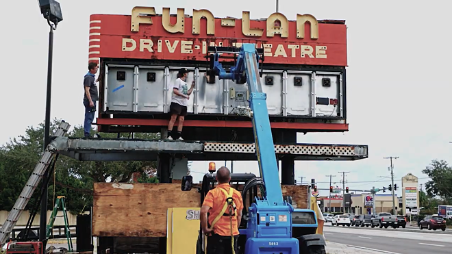 Crab Devil collective members work on dismantling Fun-Lan's historic entrance sign. - MICHAEL M SINCLAIR/YOUTUBE