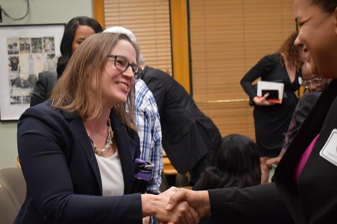 Lynn Hurtak (L) shakes hands with Meredith A. Freeman after city council's 4-2 vote to appoint Hurtak to the council, on April 5, 2022. - PHOTO BY JUSTIN GARCIA