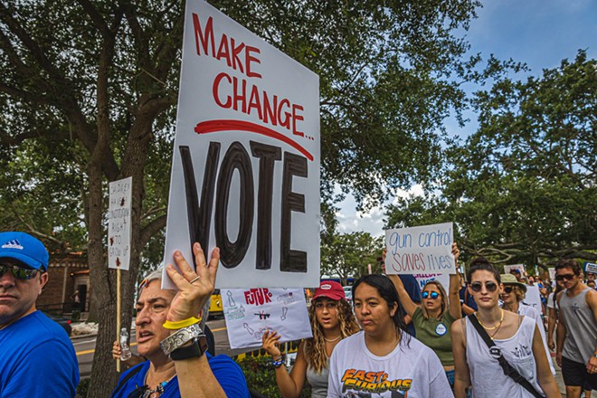 A protester with a 'Make Change... Vote' sign in St. Petersburg, Florida on June 11, 2022. - PHOTO BY DAVE DECKER