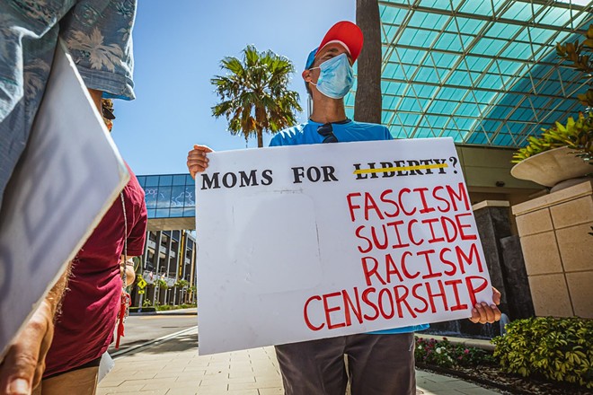 A protester outside of the Moms For Liberty summit in downtown Tampa last July. - Photo via Dave Decker