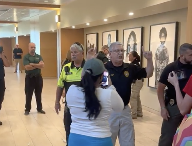 USF Police Chief Christopher Daniel yells at students during a diversity rally after arresting a young woman. - Students for a Democratic Society