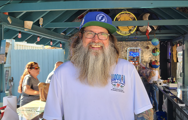 Owner Matthew Neumann poses at Hookin' Ain't Easy's outdoor bar. - Ray Roa
