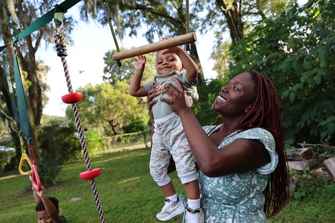 Jasmine Brown plays with her youngest son, Elijah, in the backyard of her home in Marion County, Fla., Thursday, Oct. 5, 2023. - Azhalia Pottinger/Fresh Take Florida