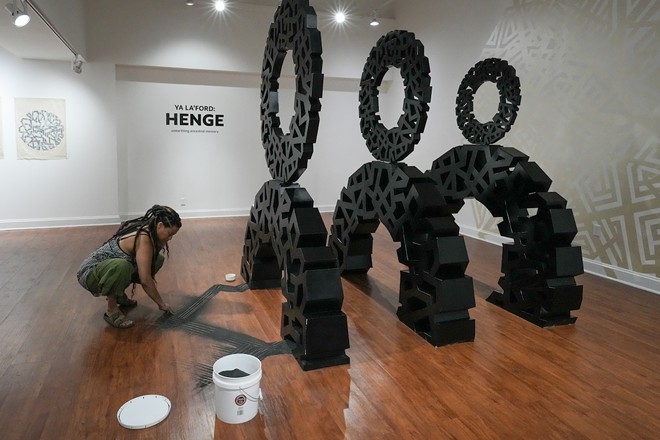 For 'Henge,' Ya La’Ford imported sand from Africa, which was then sprinkled on the gallery floor at Gallery114 in Ybor City, Florida. - Photo via Tampa Listing Lab