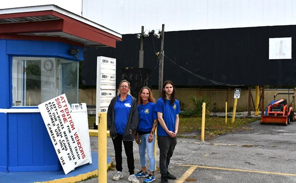 Fun-Lan workers stand next to the original ticket booth on their last day of work on the property. From left to right: Snell, Stanford and Perez.
