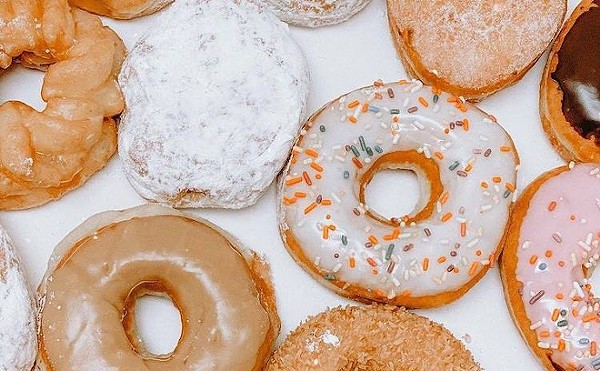 Tampa Bay Dunkin' and Krispy Kreme stores are slinging free doughnuts on Friday