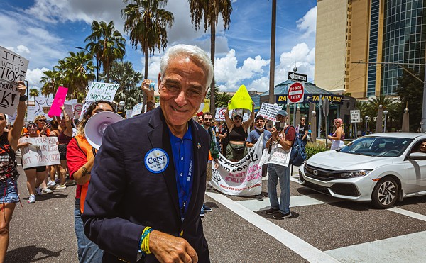 Charlie Crist is booed away by pro-choice activists outside the Tampa Marriott in July 2022.