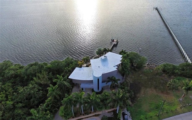 This custom concrete fortress in Bradenton comes with a three-story glass elevator