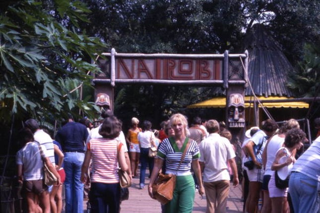 View showing visitors by the entrance to the Nairobi themed area of the Busch Gardens amusement park - Tampa.  Date unknown.