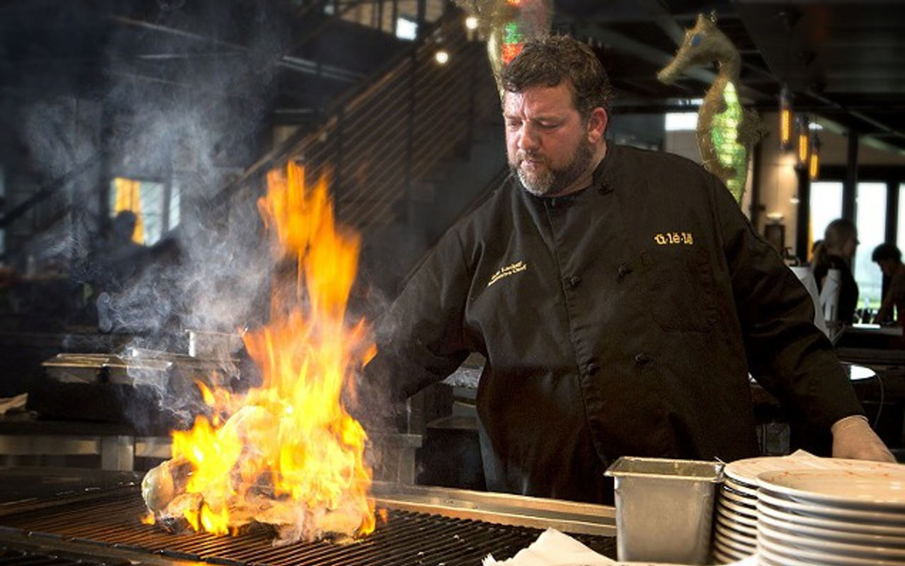 Executive chef Eric Lackey cooks behind Ulele's open grill.
