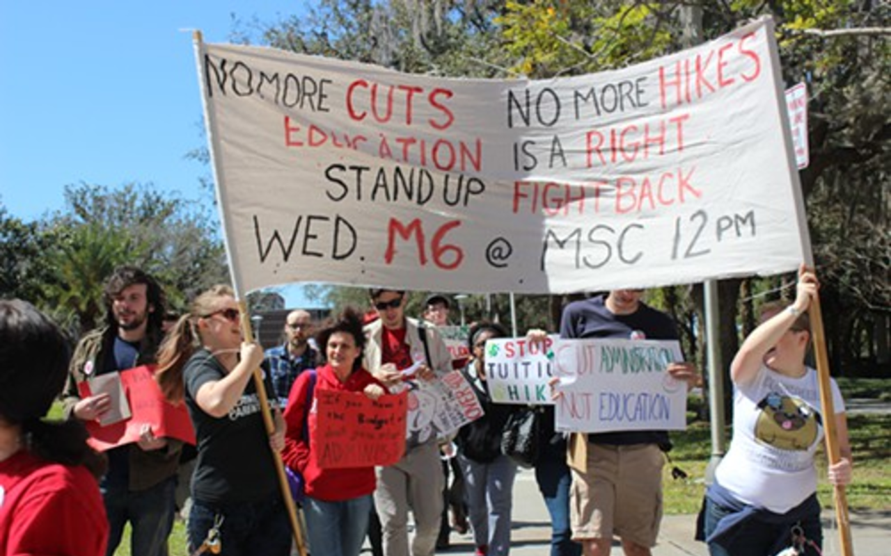 Student march across campus to protest tuition hikes.