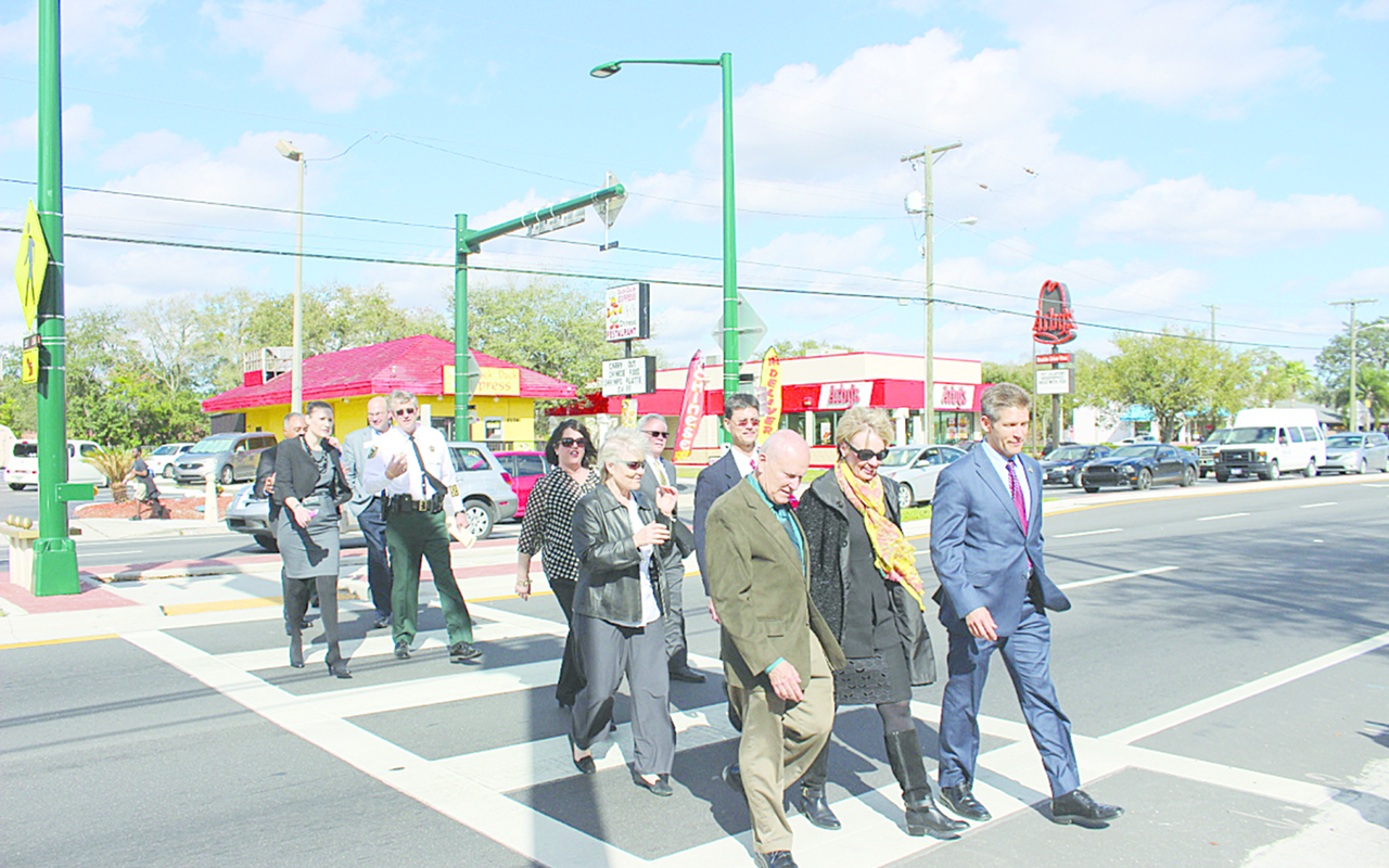 WALK THIS WAY: County and city officials use one of the new crosswalks on Fletcher Avenue in Tampa during the grand opening of the Complete Street initiative.