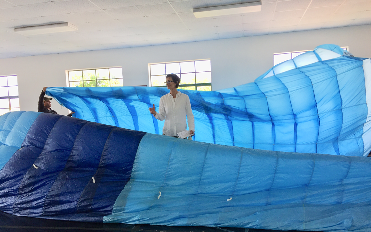 Eugenie Bondurant rides the waves (played by a blue military parachute) in a rehearsal for "Air-Earth-Fire-Water."