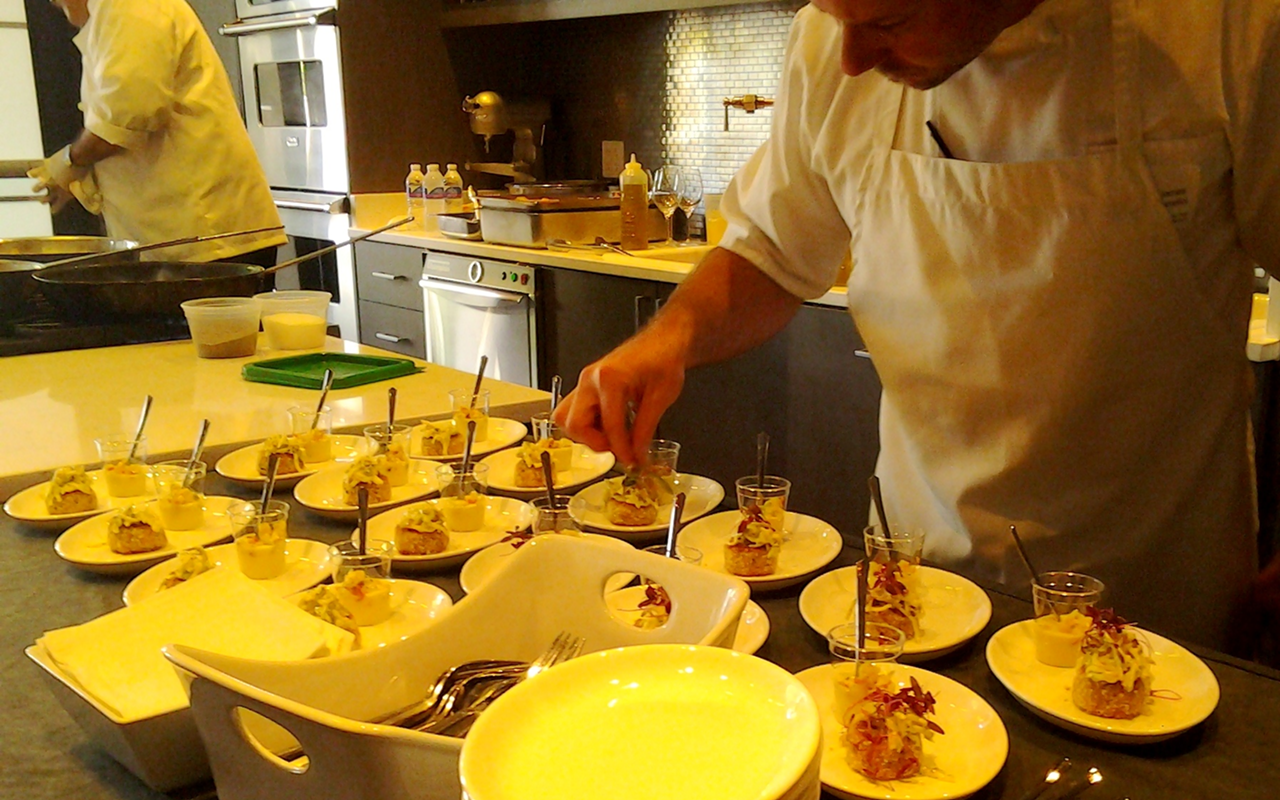 Louies Modern chef James Baselici garnishes his dishes at a media 
preview for Sarasota County's restaurant week.