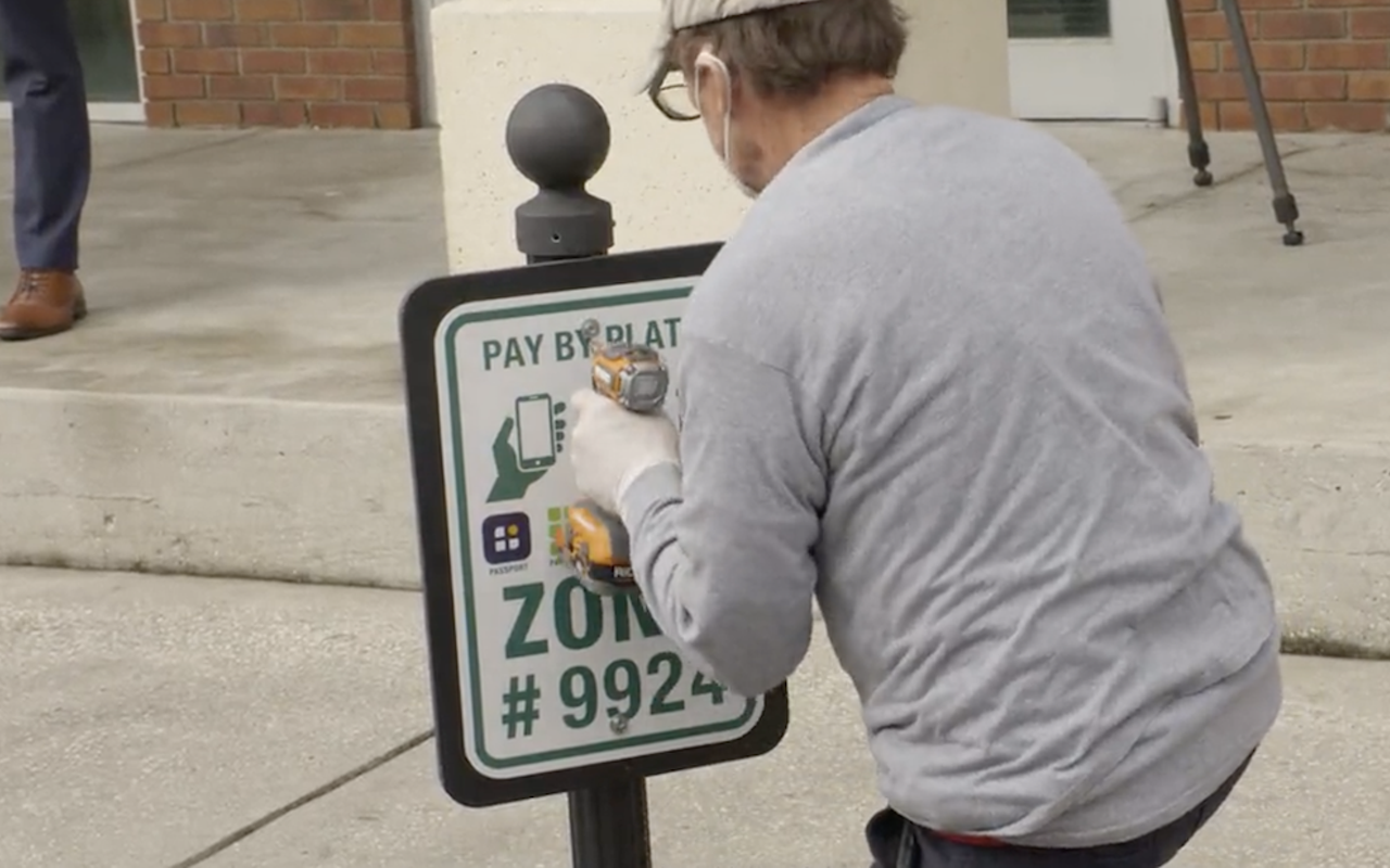 A pay-by-plate sign is installed.