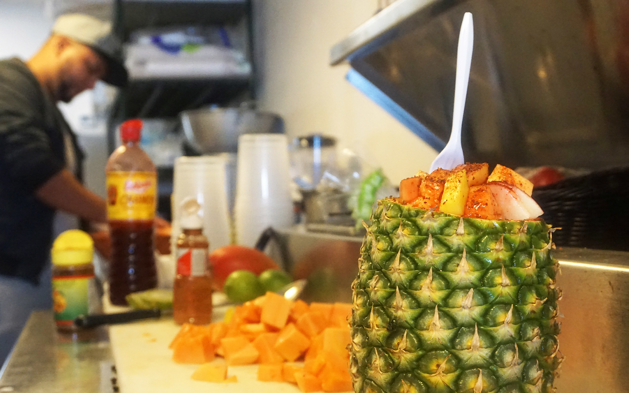 This fruit cup features papaya, pineapple, chili powder and a drizzle of Mexican condiment chamoy.